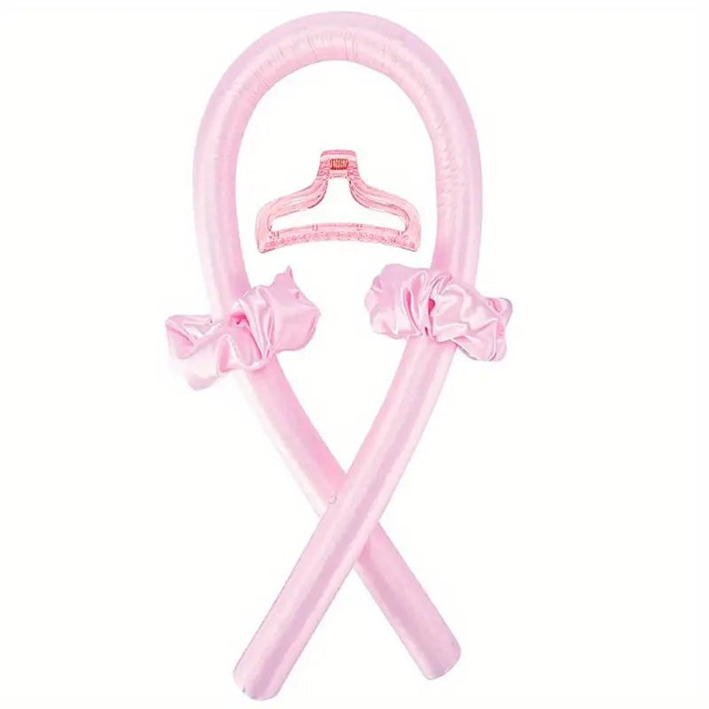 Pink heatless curling rod with claw clip and bow scrunchies on a white background