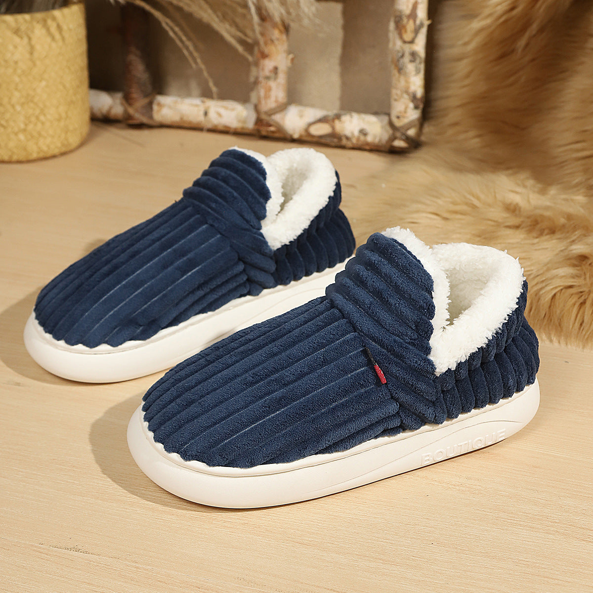 Pair of warm house slippers with round toe, fur cuff and grippy foam sole