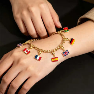 Gold cuban chain flag bracelet on a wrist with multiple enamel flag charms