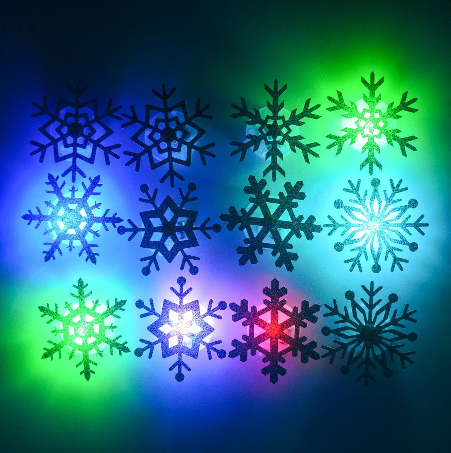 Silver glitter snowflake wall stickers laid out showing the assorted geometric designs