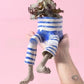 Resin lower body planter with dangling legs and painted shoes holding a small plant