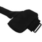 Black armband with a dotted inside surface and a plastic slide buckle, close up on white