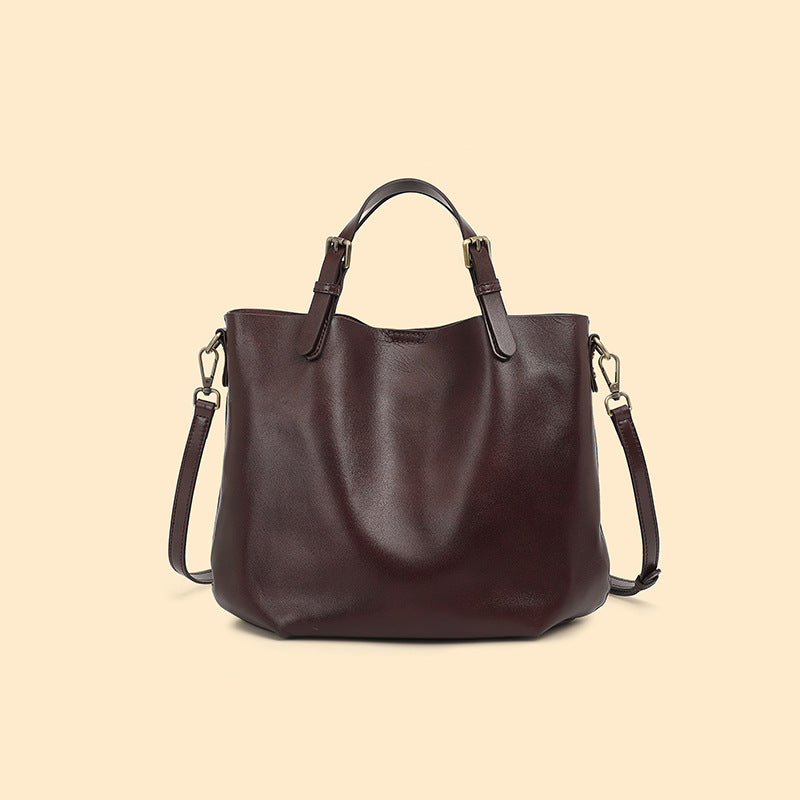 Coffee brown cowhide leather bucket tote with top handles and a shoulder strap, coffee brown option