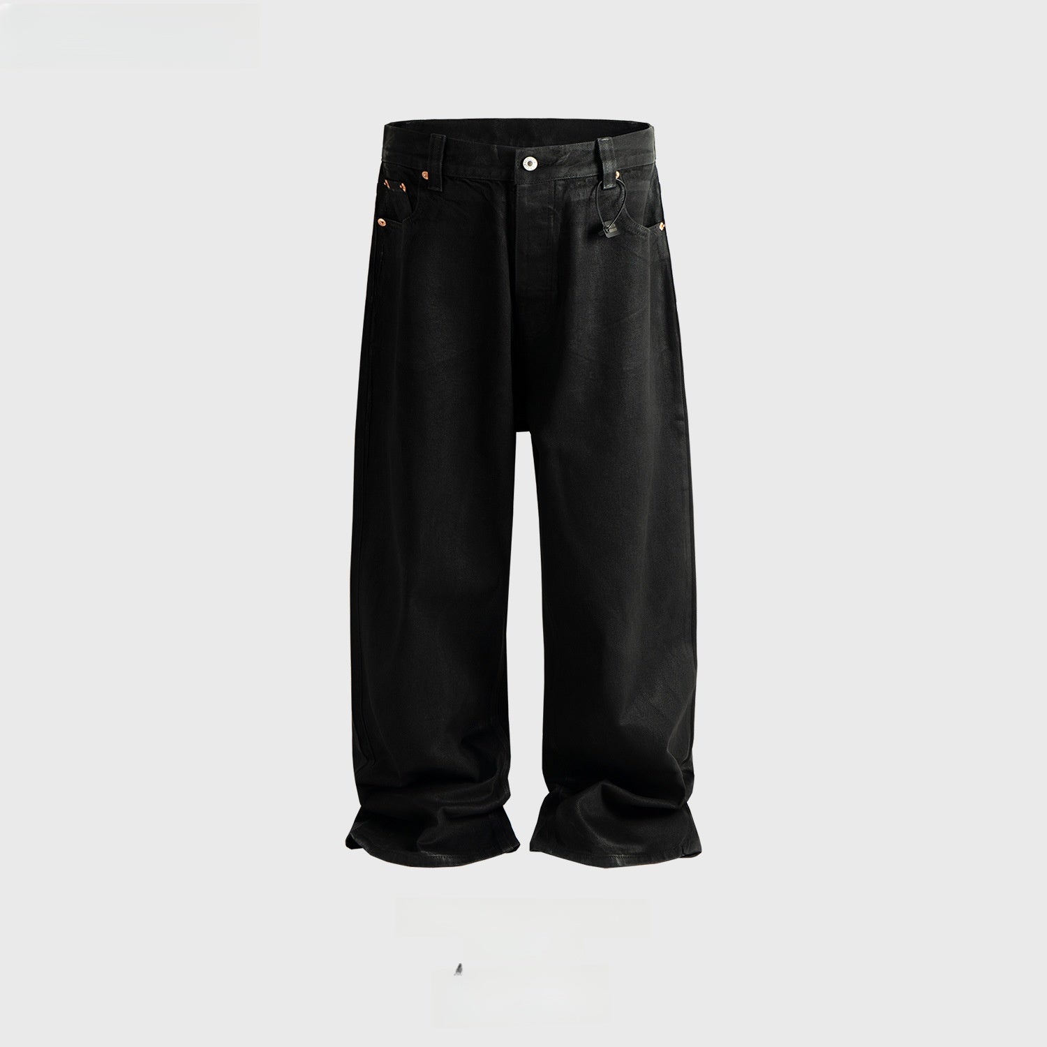 Black waxed coated denim jeans laid flat, roomy unisex leg and rose gold five pocket hardware on show