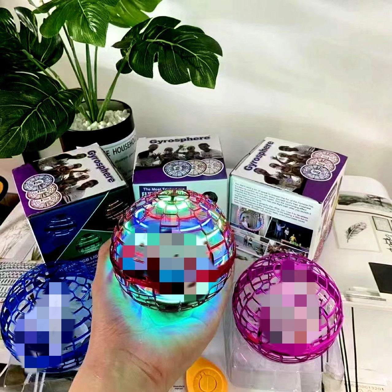 Flying spinner toy set on a flat surface beside its USB charging cable
