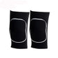 Pair of black dance knee pads with white edge binding on a white background