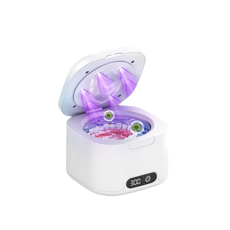 White ultrasonic cleaner with the lid open, a purple UV glow and a stainless steel tank with an LED timer