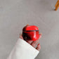 Marble AirPods protective cover case held in hand showing the snap seam