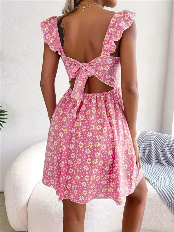 Close view of the ditsy floral print and ruffled shoulder straps on the mini dress