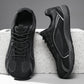 Black mesh lace-up sneakers with a flat black rubber sole on a concrete block, size 41 option photo