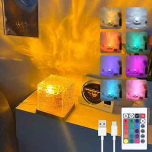 Cube water ripple lamp glowing amber on a shelf with color preview tiles, remote and USB cable