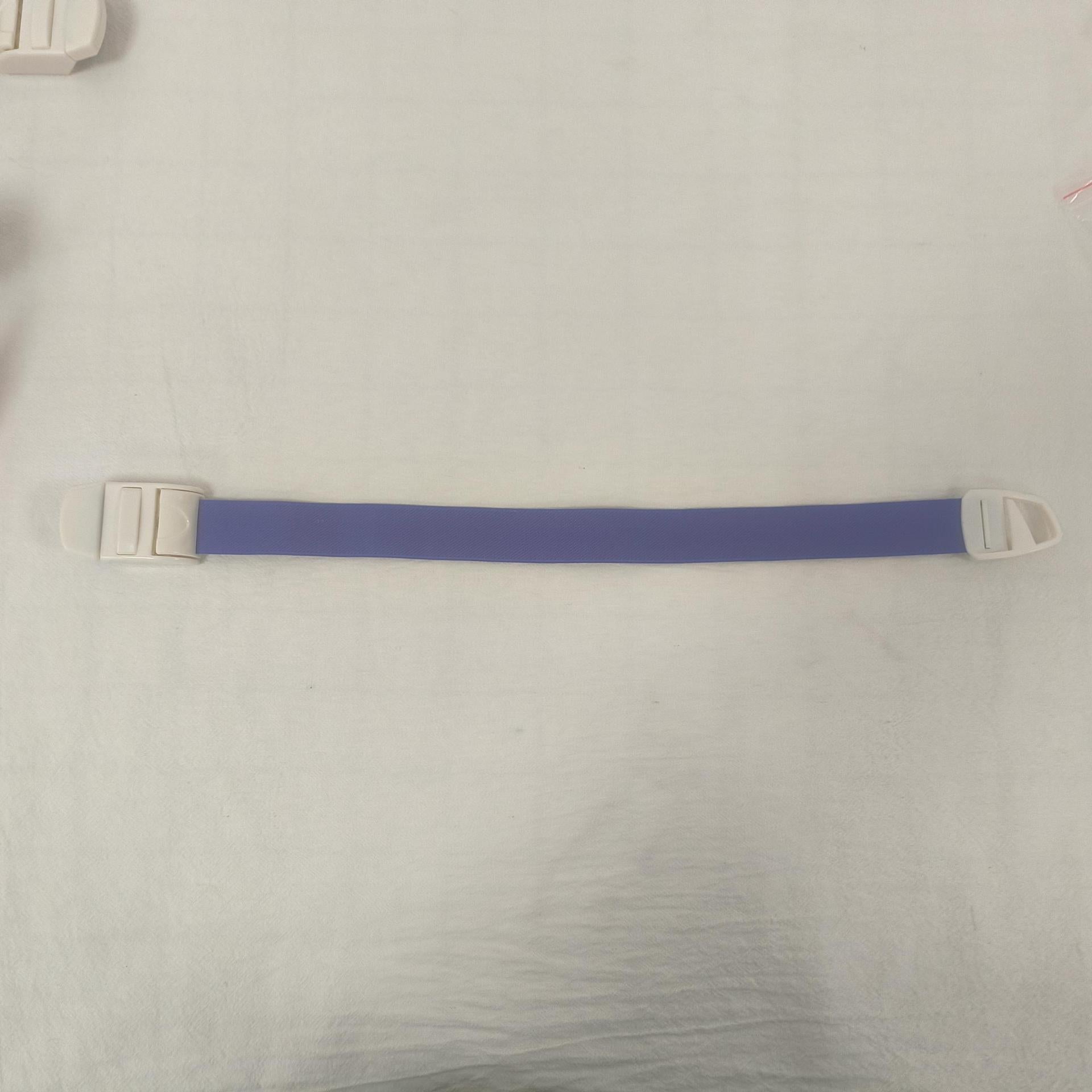 Single purple elastic quick release tourniquet band laid flat with its white snap buckle