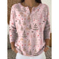 Christmas print knit top shown in a modern interior context
