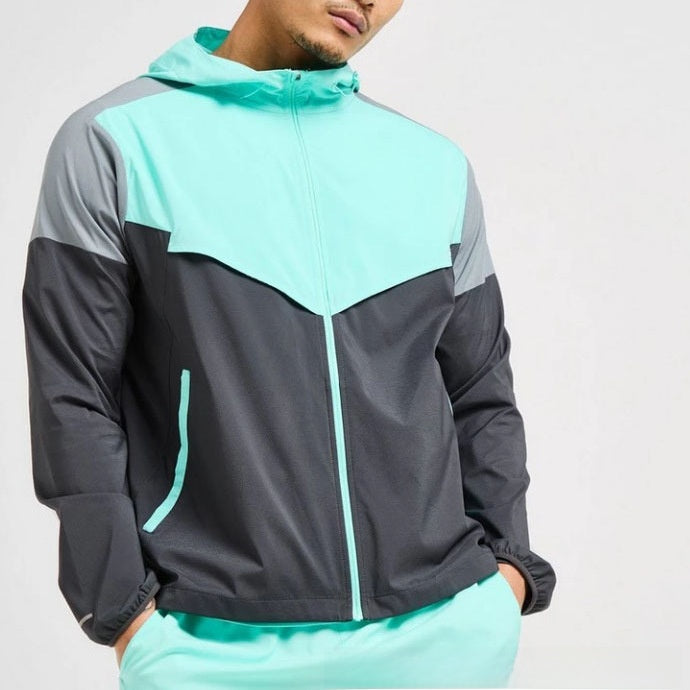 Full length view of a colour block hooded sports jacket and matching shorts on a male model