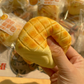 Slow-rebound pineapple bun squishy held in one small hand for fidget play