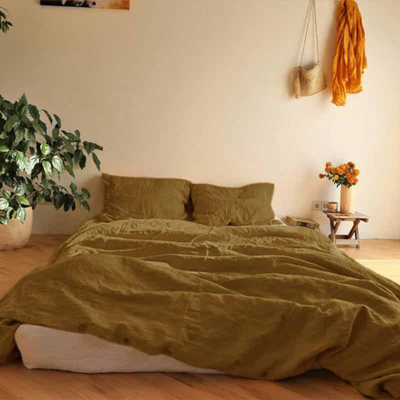 Solid color washed linen duvet cover on a bed in soft natural daylight