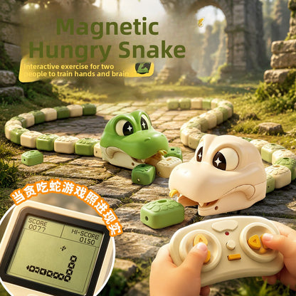 Green and beige remote control magnetic snake toys with the 2.4G controller on a stone path