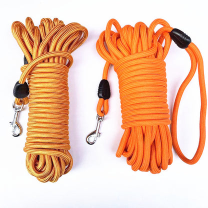Gold and orange round nylon dog training long lines coiled with metal snap clips