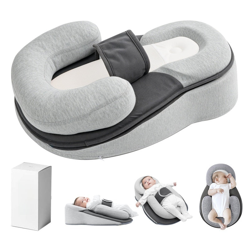 Grey baby lounger shown with its box and small in-use views of a baby resting on the sloped pad