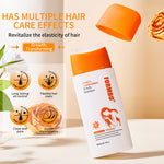 White oil control shampoo bottle with orange applicator brush cap open above it beside a rose