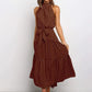 Brown polka dot halter neck sleeveless tiered swing maxi dress worn by a model