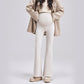 Beige maternity bell-bottom pants with a high-waist belly panel, size L option, worn with a camel coat