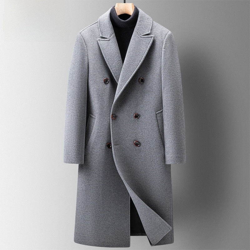 Grey double-breasted long coat with peak lapels on a hanger over a black turtleneck, front view