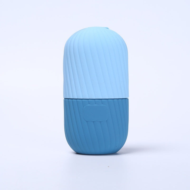 Coral silicone facial ice tool upright, textured surface catching soft studio light