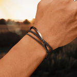 Black stainless steel layered bracelet set of three chains on a mans wrist