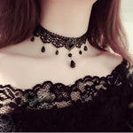 Black lace choker necklace with a faceted cabochon centre and bead drops worn at the neck