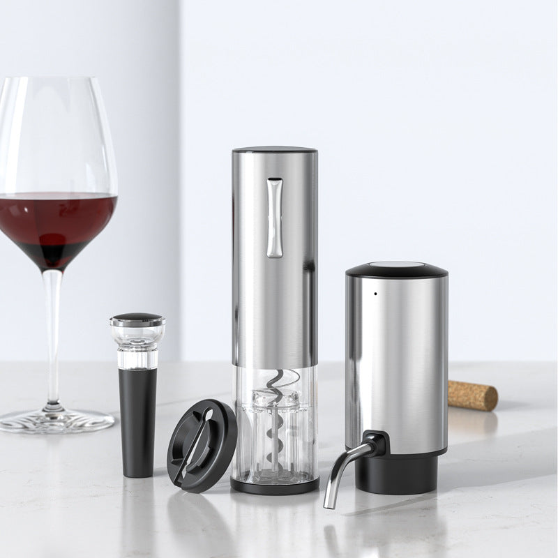 Brushed steel electric wine opener, vacuum stopper, foil cutter and aerating pourer by a wine glass
