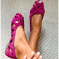 Interlaced suede straps forming the open cage vamp of a flat sandal