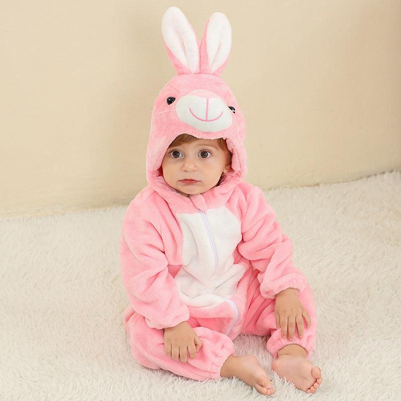 Baby in a pink rabbit flannel romper with a hood and long ears, sitting on a cream rug