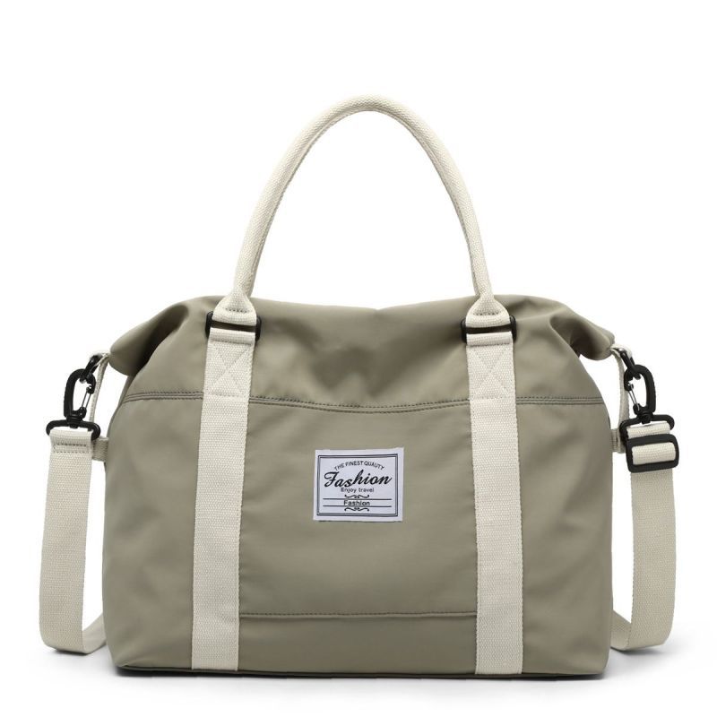 Green weekender bag shown with removable crossbody strap