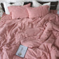 Cotton and linen blend bedding with a relaxed washed texture, shown in a modern bedroom