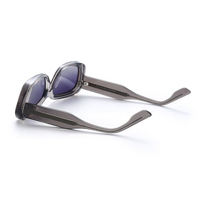 Transparent gray retro square sunglasses shown from the side with thick tapered acetate temples