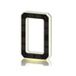 Black and gold solar LED house number sign, one character with a backlit warm outline, three quarter view