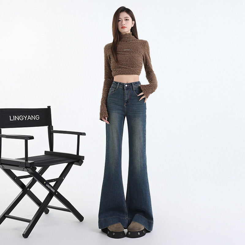 Front view of indigo flared denim trousers showing button and zip fly