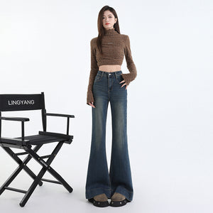 Front view of indigo flared denim trousers showing button and zip fly