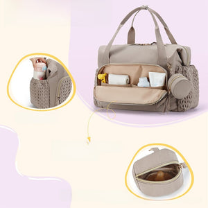 Diaper bag with the front pocket dropped open on wipes and a bottle, plus side pocket and pacifier pouch insets