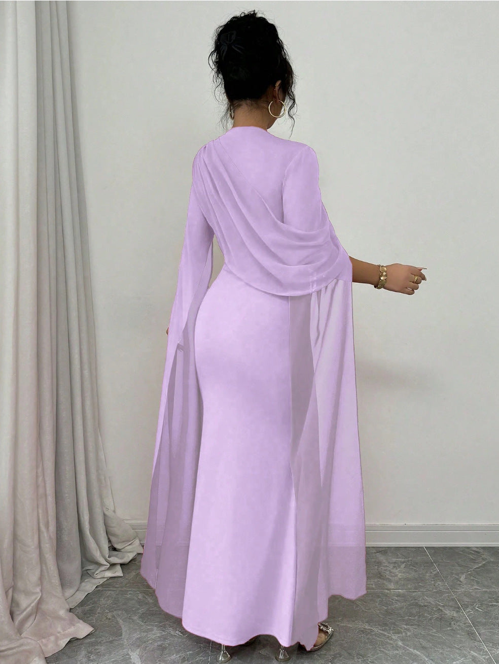 Lilac chiffon cape sleeve long gown with cinched waist and floor length skirt, on model
