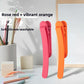 Two piece set of silicone bookmark clips in rose red and vibrant orange on a desk