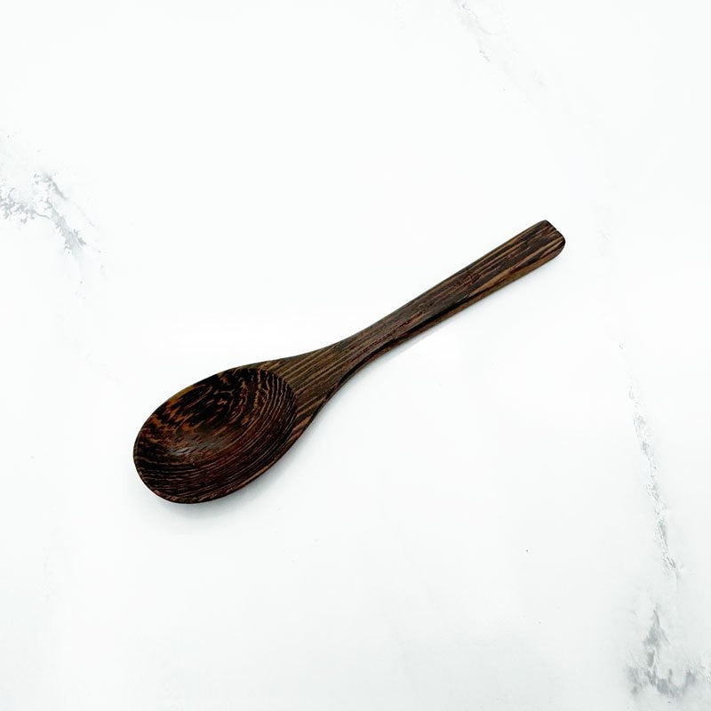 Coconut Shell Bowl with Wood Utensils | on a clean studio background