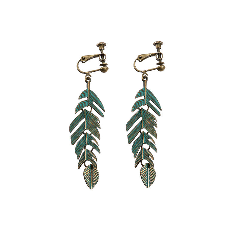 Bohemian vintage clip-on tassel drop earrings on a zinc alloy frame, handmade boho pair on white studio background