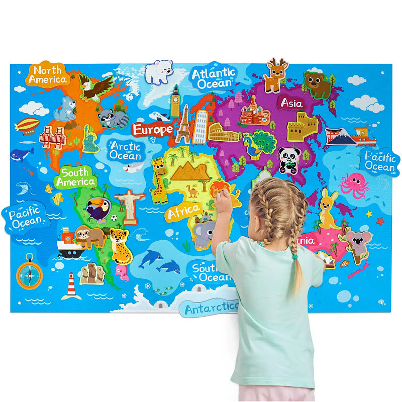 Girl placing felt continents and animals on a world map themed hanging felt story board