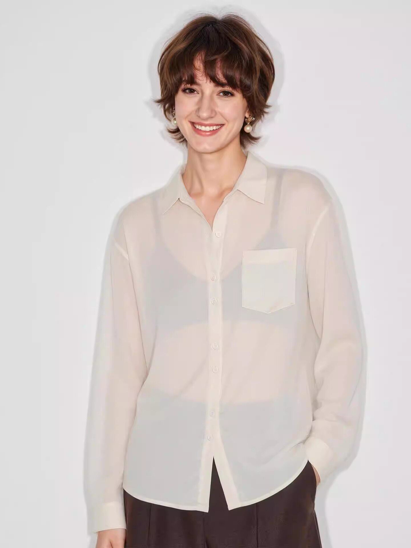Detail of the woven Tencel and linen fabric texture on a lightweight button-up shirt