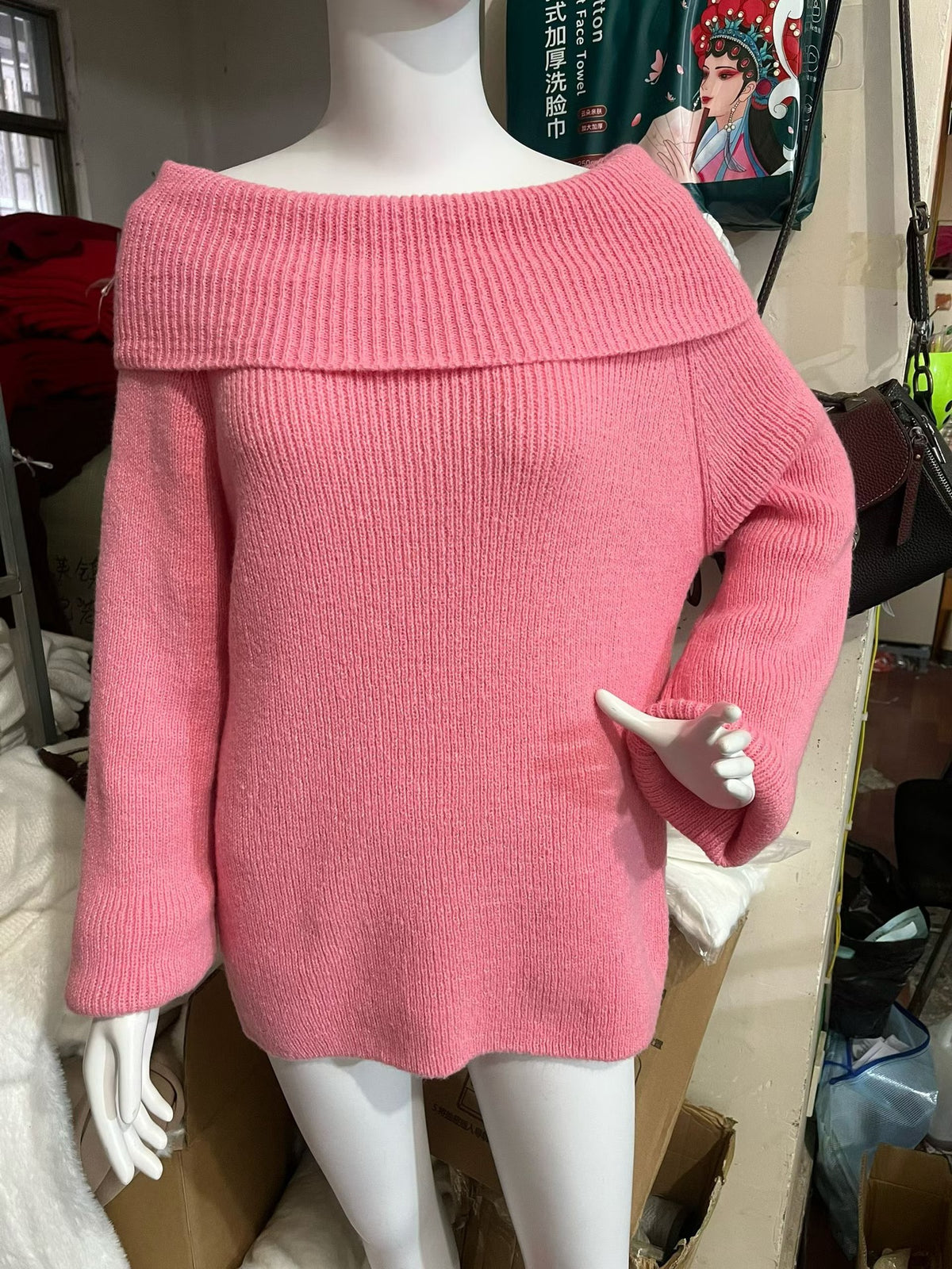 Rose pink off-shoulder fold-over knit sweater with wide sleeves shown on a mannequin