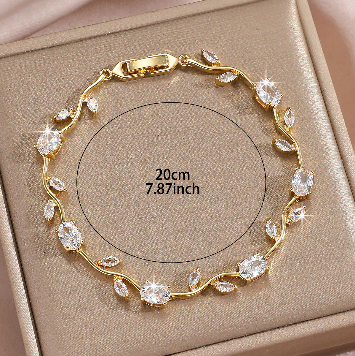 Gold plated zircon leaf bracelet arranged on a clean studio background