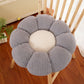 Flower shaped plush seat cushion on a chair in a cozy reading corner