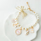 Adjustable faux pearl cat collar showing the gold lobster clasp and extender chain closure